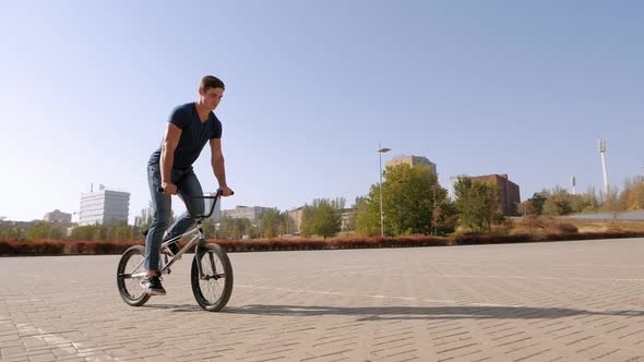 Teenage BMX Rider Is Performing Tricks in Skate Park.