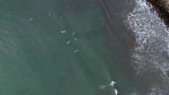 AERIAL: drone, surfers breaking the waves, steady view