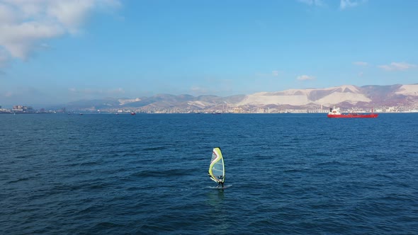 Aerial View of Windsurfer Surfing in in Calm Deep Blue of Sea, Extreme Sport