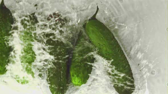 Super Slow Motion Cucumbers Fall Into the Water with Splashes