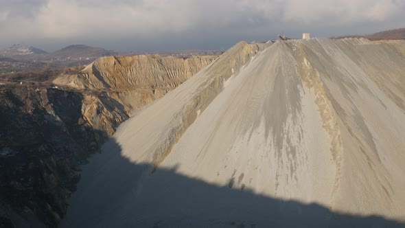 Tilting on open-pit mine soil layers 4K 2160p 30fps UltraHD footage - Polluted area with mineral flo