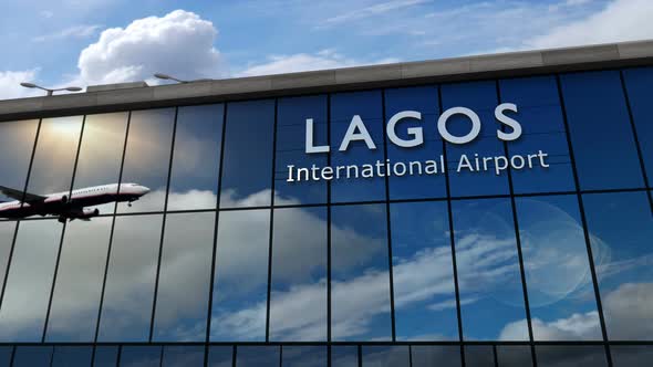 Airplane landing at Lagos Nigeria airport mirrored in terminal