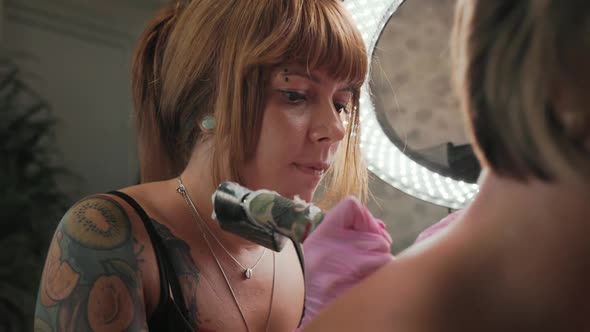 A Closeup of a Tattoo Master Doing a Tattoo