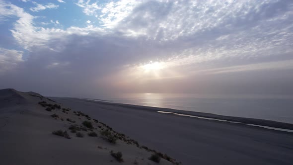 Dawn on the Sandy Beach of the Sea