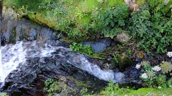 Stream of water coming from the watermill in Boscastle village in Cornwall, England. Limestone rock