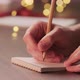 Man Writes Shopping List Holidays Notepad Pencil Under Warm Light Evening - VideoHive Item for Sale