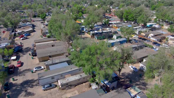 A high dolly shot of a poor low income neighborhood.  Mobile homes in 2021.