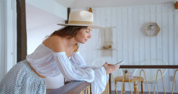 Fashionable Woman Stands at the Cafe and Types the Text Massage She Smiles and Happy to Answer