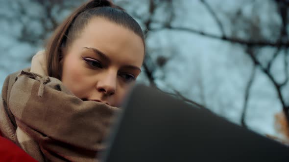 Woman works a laptop closeup alt
