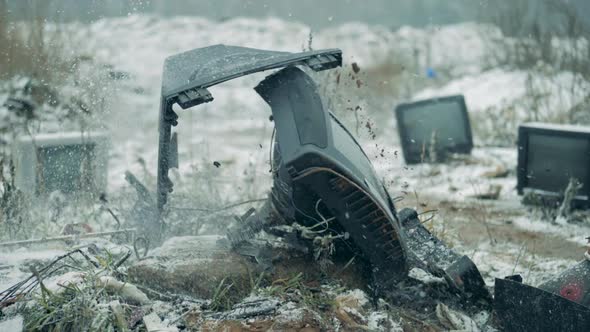 One TV Falls on a Dump, Breaking Apart.