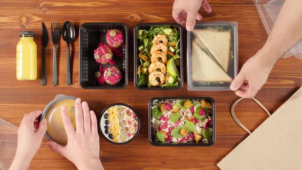 Food Delivery Top View Closing Take Away Meals in Disposable Containers on Wooden Table