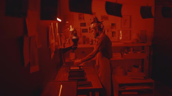 Indian Photographer Printing Film in Darkroom