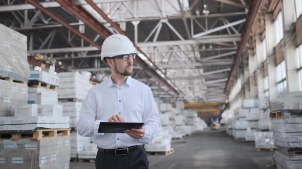 Employee Male Warehouse Worker Engineer Man in Hard Hat Working at Construction Site Warehouse