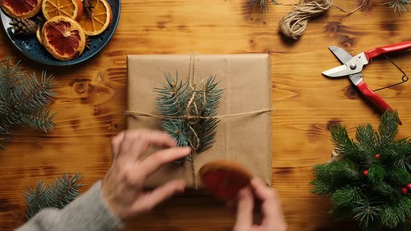 Hands Decorates Christmas Gift Box