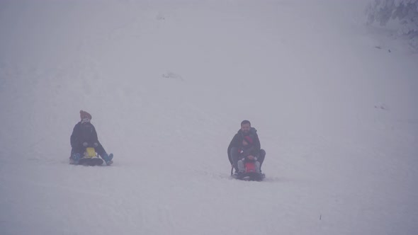 Child and father skiing in the snow.