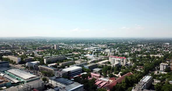 Top View of Almaty City. Green Streets, Big Clouds