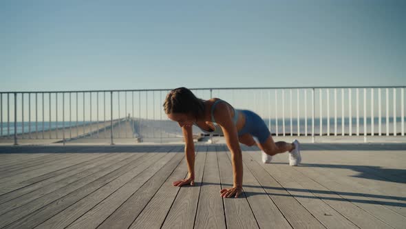 Sportswoman Workout Outdoor on Seaside  She Make Burpee Exercise