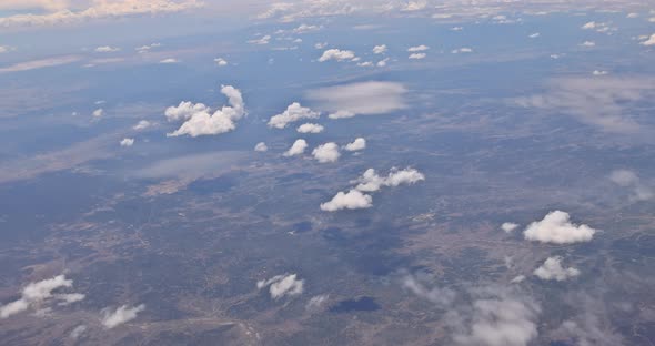 View From Plane During Flight Over of Fluffy Clouds desertNew Mexico USA