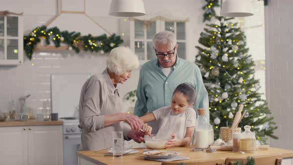 Little Girl Helping Grandparents Baking in Kitchen