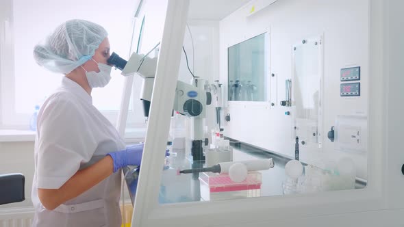 Female Scientist Looking Microscope Eyepiece. Portrait of Woman Scientist Looking Through Microscope