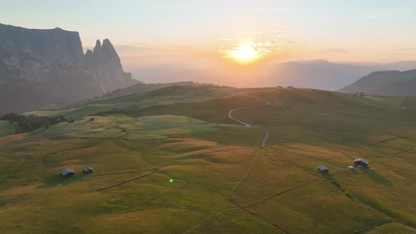 Sunrise in the Dolomites mountains with fog and mist.