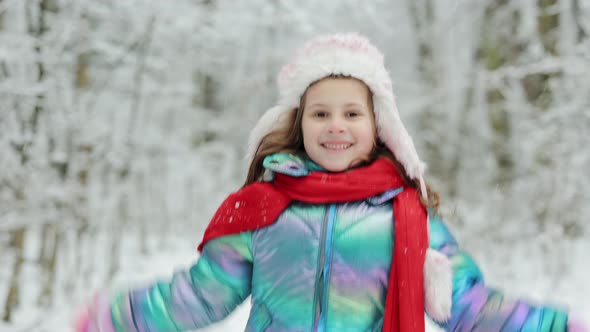 Happy Girl Plays With a Snow in Winter Day alt