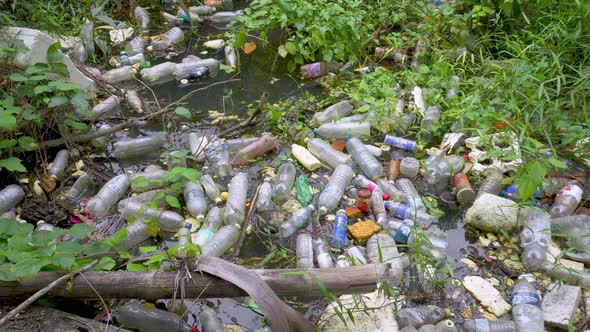 Tilt shot plastic bottle garbage at river