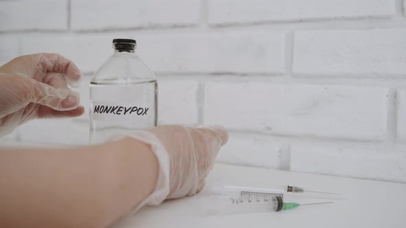 Hands in Gloves Paste Sticker on Medical Flask with Inscription Monkeypox