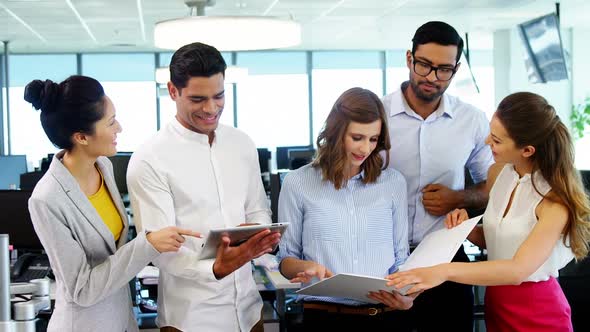 Business colleagues discussing over document