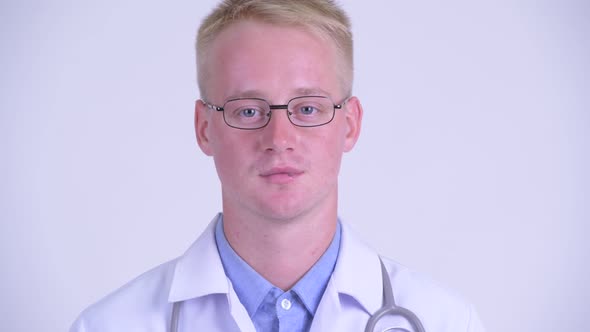 Face of Happy Young Blonde Man Doctor Smiling