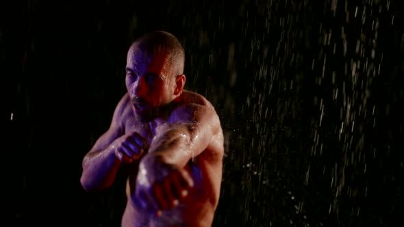 Master of Martial Arts is Practicing Punches By Arms in Rain in Dark Night