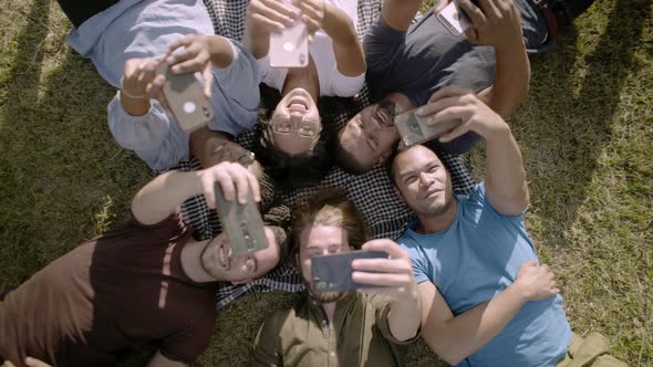 Top View of Glad Young People Using Smartphones