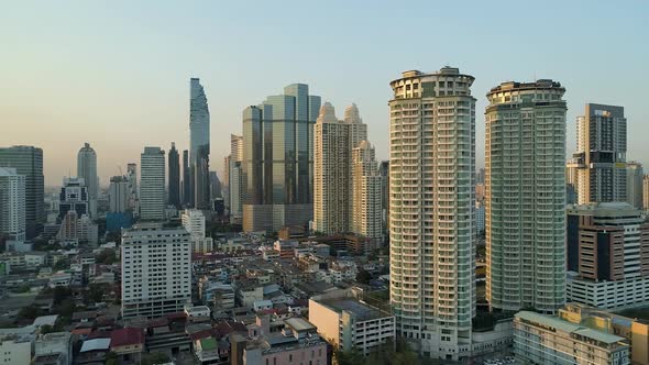 Bangkok skyline with clear blue sky, aerial dolly left