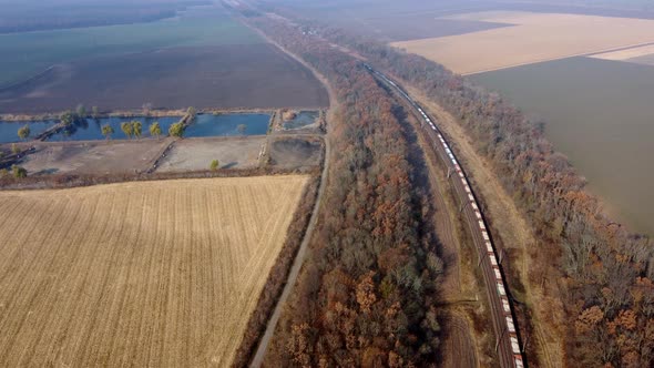 Panoramic Moving Freight Train Along Railway Tracks Trees Agricultural Fields