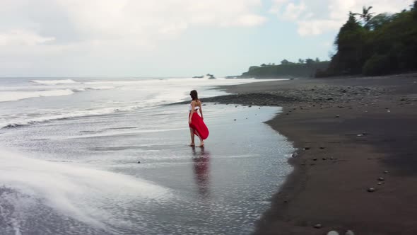 Young Woman Enjoying Vacation on Black Sand Beach