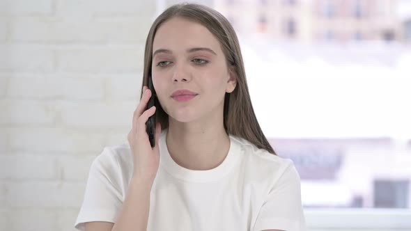 Portrait of Cheerful Young Woman Talking on Smartphone