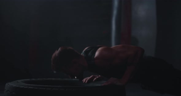 Athletic Man Doing the Push-ups Over a Large