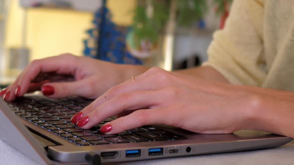 Slow Motion Macro Girl Types Text on Notebook Keyboard