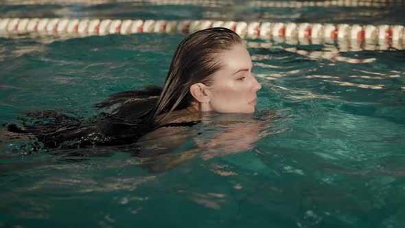 The Woman Swims in the Pool