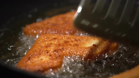 Fried Cheese Gets Flipped on the Other Side on a Pan with Sizzling Oil  Closeup
