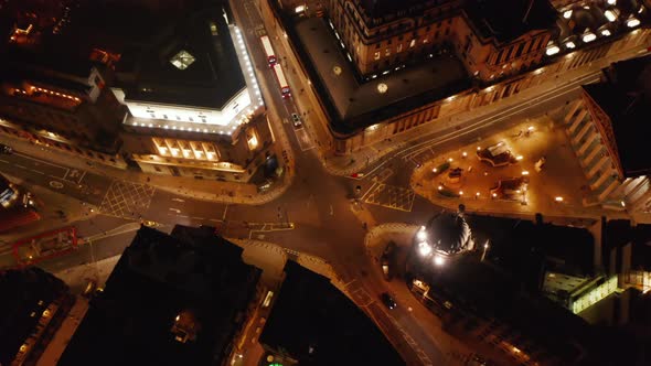 Aerial View of Cars Driving Through Star Shaped Road Intersection