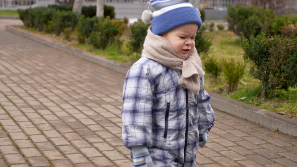 Sad Toddler Cries. Old Woman Gives Apple. Slow Motion Falling Snow