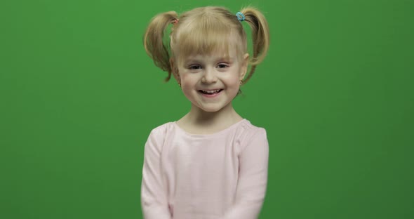 Happy Little Girl in Pink T-shirt. Cute Blonde Child. Dancing and Make Faces