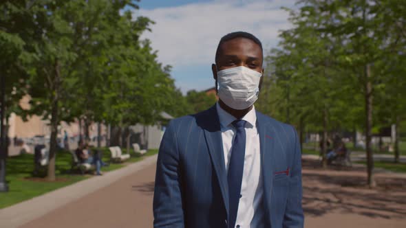 Young African Businessman Wearing Mask for Protection From Corona Virus Outbreak Walking Outdoors