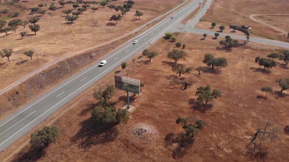 Aerial view of driving cars on road in Beja between dry desert in summer,Portugal