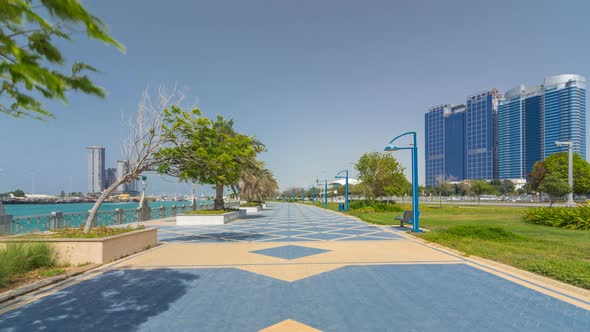 Corniche Boulevard Beach Park Along the Coastline in Abu Dhabi Timelapse Hyperlapse with Skyscrapers