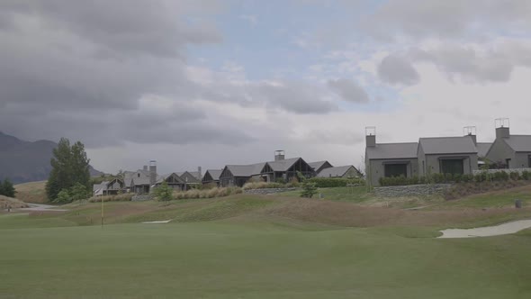 Golf field with a flag on the distance. Filmed on gimbal. Slow motion