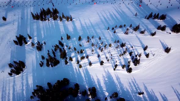 Ski in the Alps with ski lift and people skiing on the slope. Aerial view