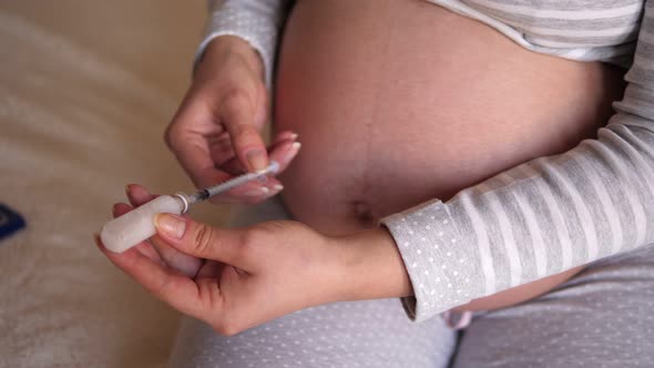 Pregnant Woman Makes Injection of Insulin in Her Belly