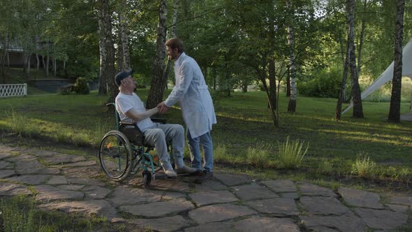 Doctor and Old Man on Wheelchair Meets in the Park